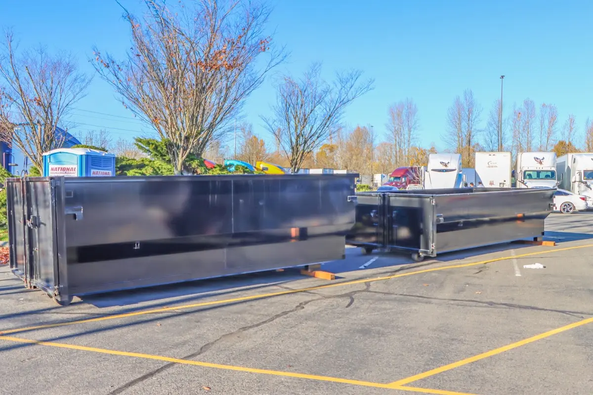 Professional dumpster rental service with roll-off container on residential driveway in Schenectady